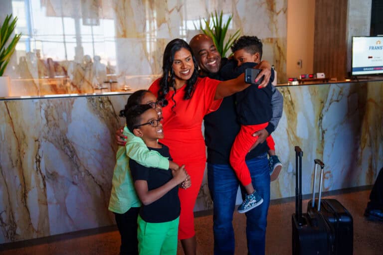 Family in the lobby of the Grand Times Hotel in Laval
